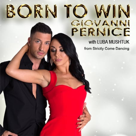 Giovanni Pernice and Luba Mushtuk pose together, both dressed elegantly against a snowy background.