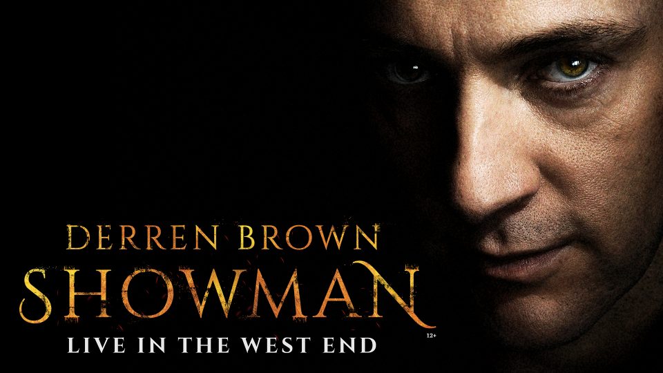 Close-up of a man’s face in shadow, with text 'DERREN BROWN SHOWMAN' in gold.