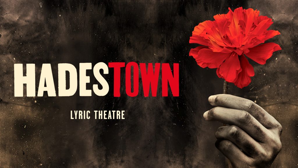 Red flower held against dark background with "Hadestown" and "Lyric Theatre" text in bold letters.