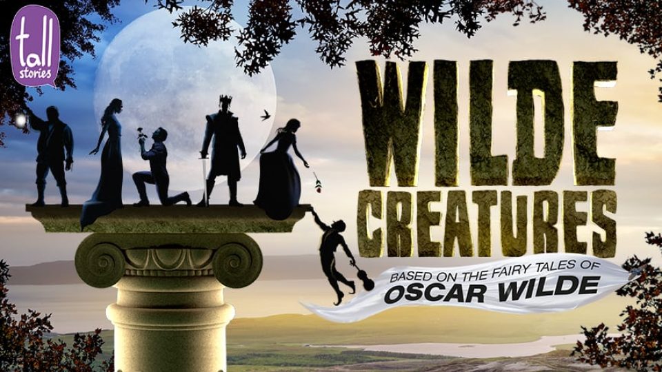 Silhouetted figures on a column, with a moonlit sky and mountains in the background.