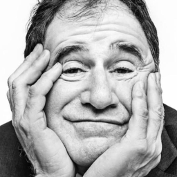 A close up portait of Richard Kind, with his hands on his face