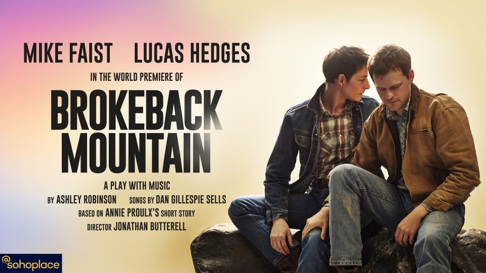 Two men in denim jackets seated closely, with a soft gradient background.