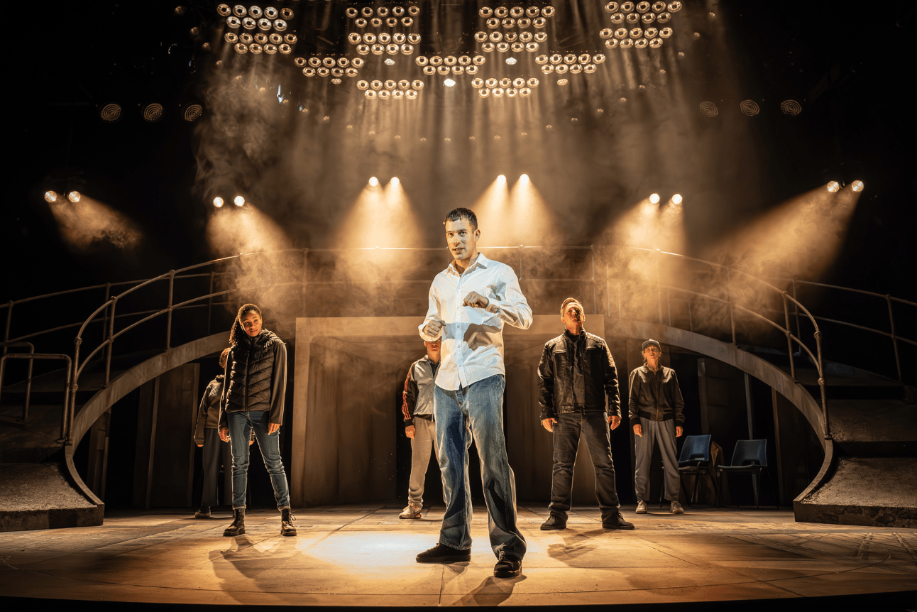 Punch actors standing in front of gold lighting