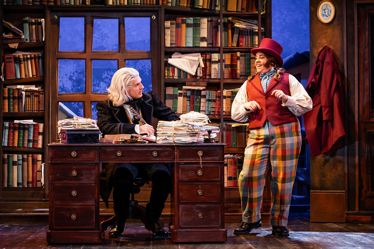 Daniel Fraser and Nancy Zamit stand side by side, smiling against a plain grey background.