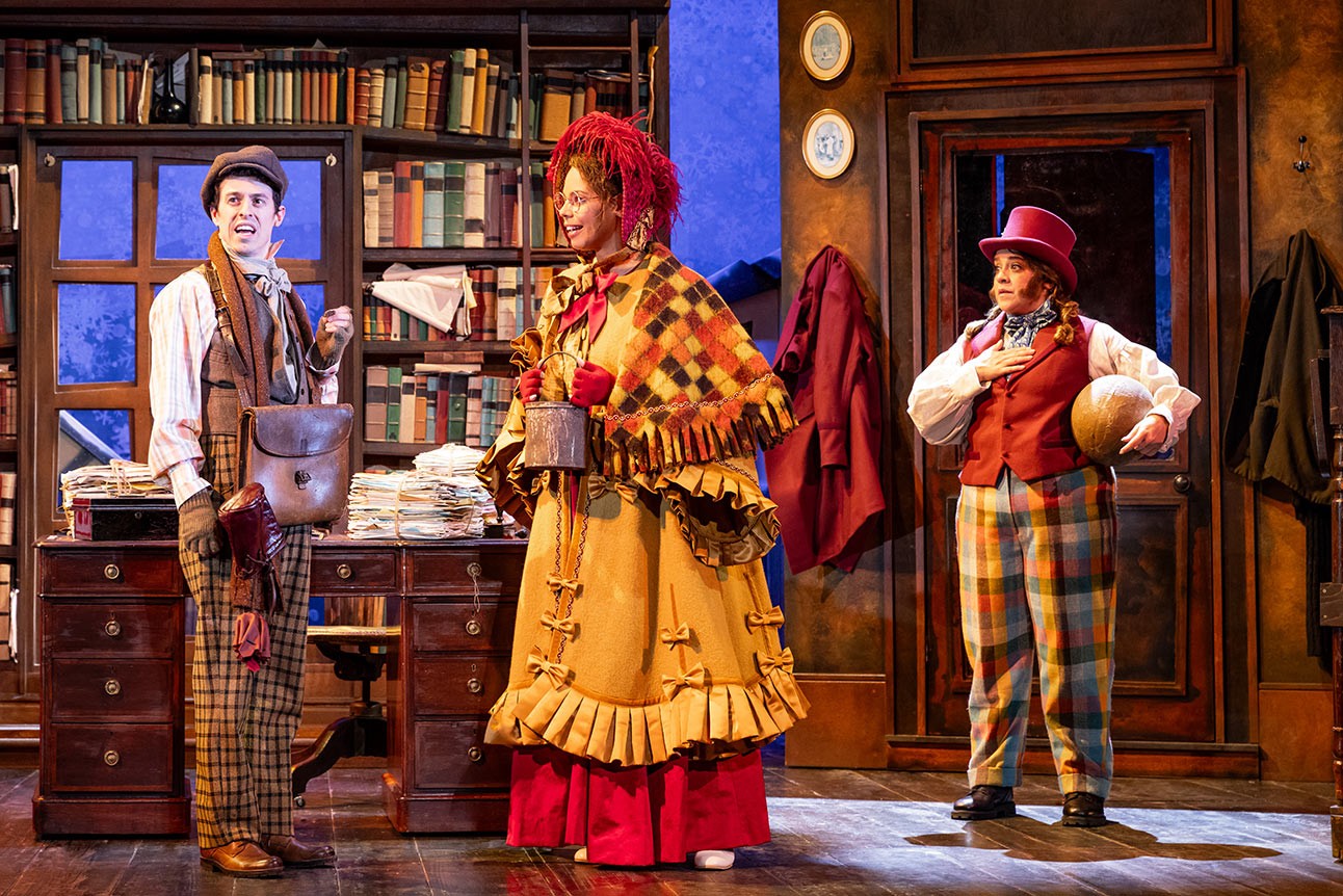 Jonathan Sayer, Sasha Frost, and Nancy Zamit smile together against a plain background, dressed in casual attire.