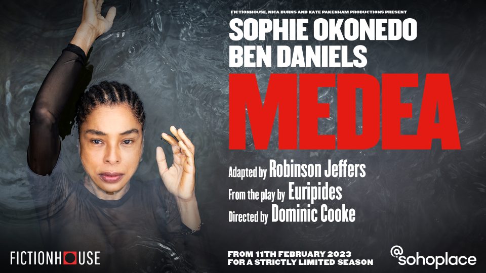 A woman partially submerged in water, raising her arm, with a focused expression.