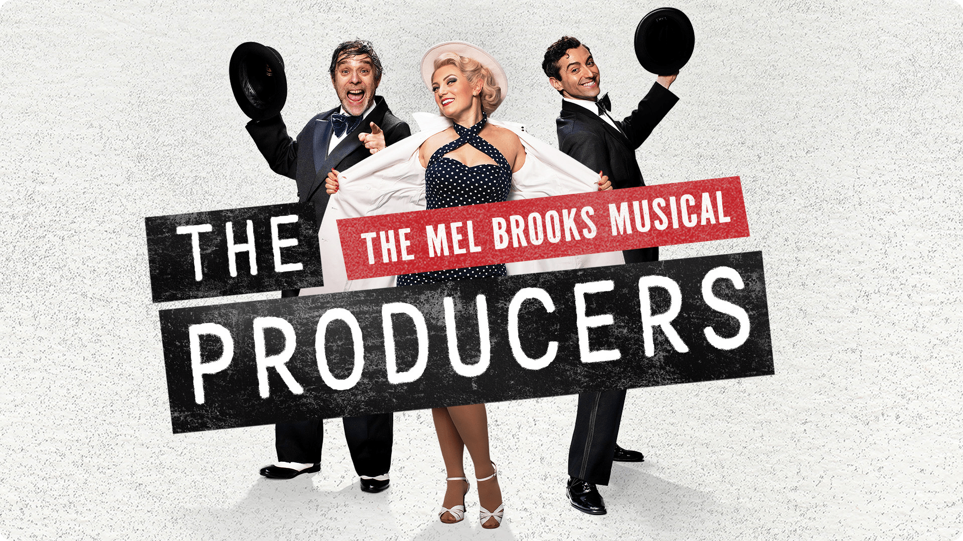 Three performers in vintage costumes, including a polka dot dress, pose with hats for "The Producers.