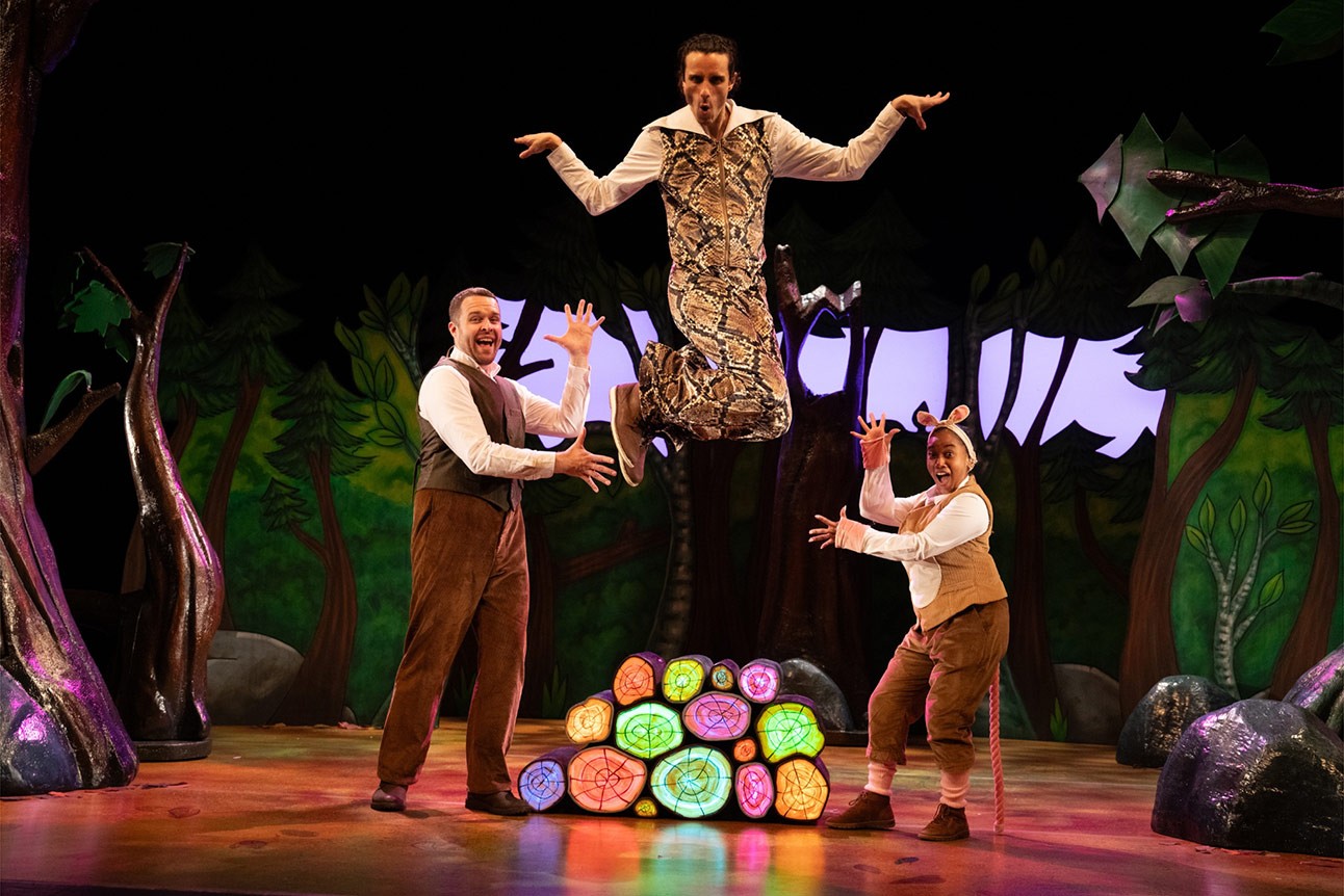 Niall Hemingway, Jordan Cottle, and Rianna Kellman perform energetically on stage in colourful costumes.