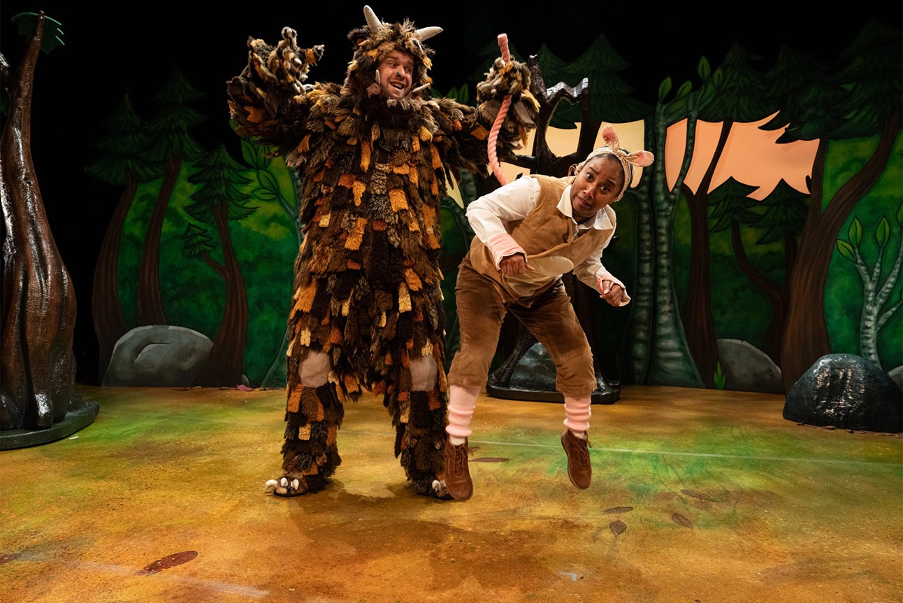 Niall Hemingway and Rianna Kellman perform in animal costumes on a colourful stage with forest backdrop.