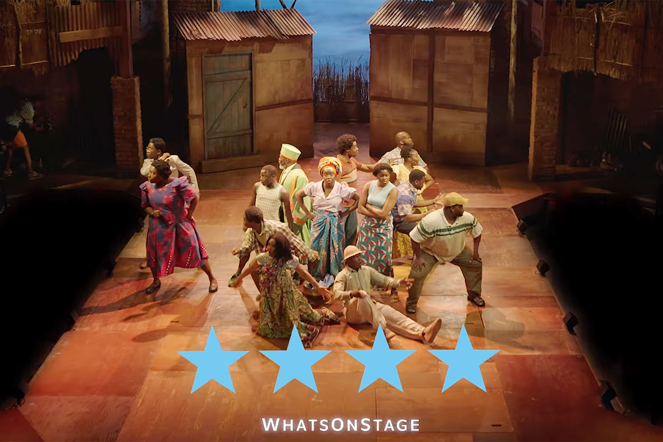 A group of actors perform energetically on stage, surrounded by rustic set pieces, with four stars below.