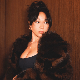 Two women in evening dresses hold awards on stage; a large screen displays "Stalls To Stage Awards".