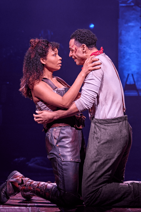 Eurydice and Orpheus hold each other closely and tenderly