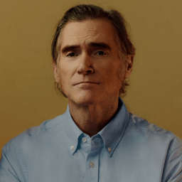 Billy Crudup against gold background.