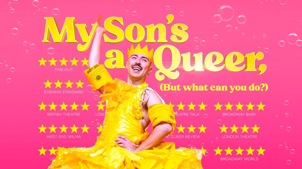 Person in yellow dress and crown poses joyfully against pink background with "My Son's a Queer" text.