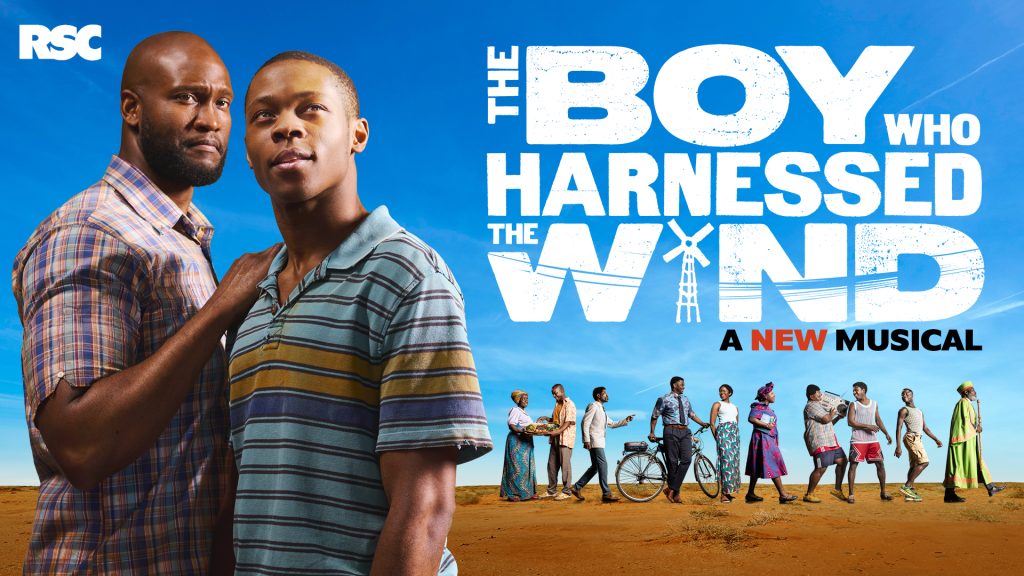 Two men stand against blue sky; group in background, text reads "The Boy Who Harnessed the Wind".