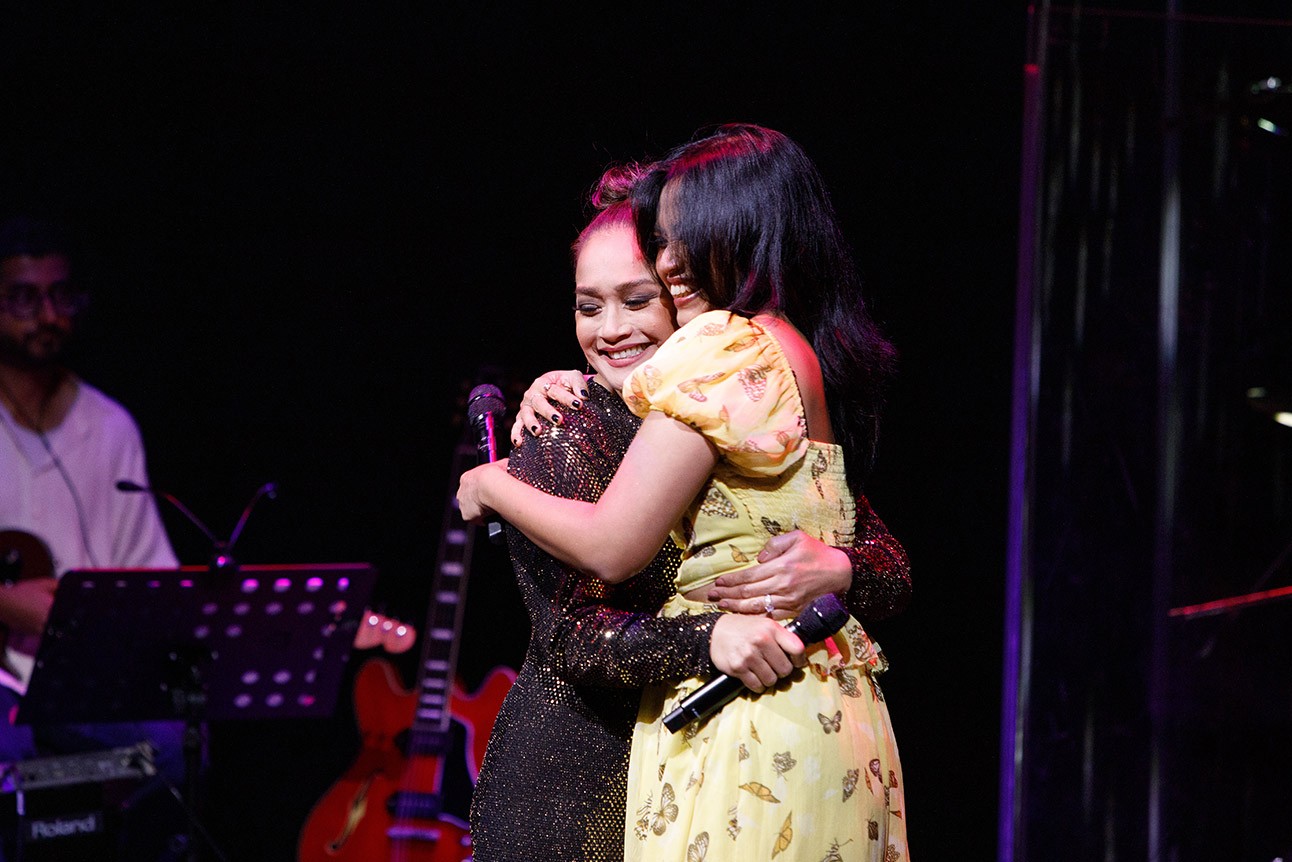 Joanna Ampil and Desmonda Cathabel smiling and embracing in RepresentAsian: An Evening of Asian Talent 2025