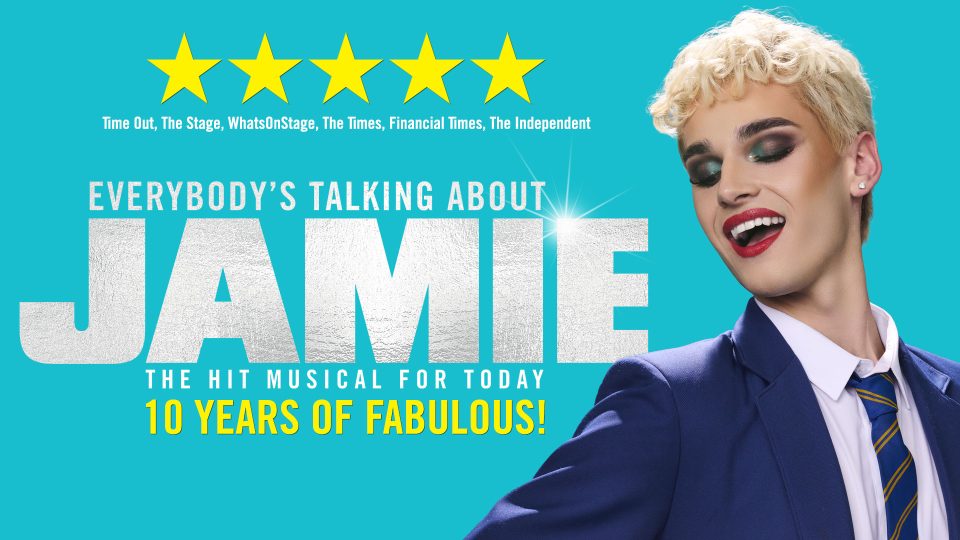 Person with blonde hair smiling against blue background, text: "Everybody's Talking About Jamie, 5 Years of Fabulous!