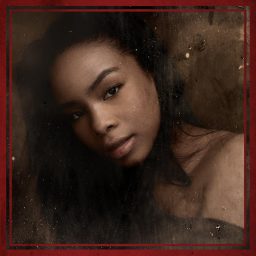 A woman with long dark hair and soft lighting, framed in a textured, reddish-brown border.