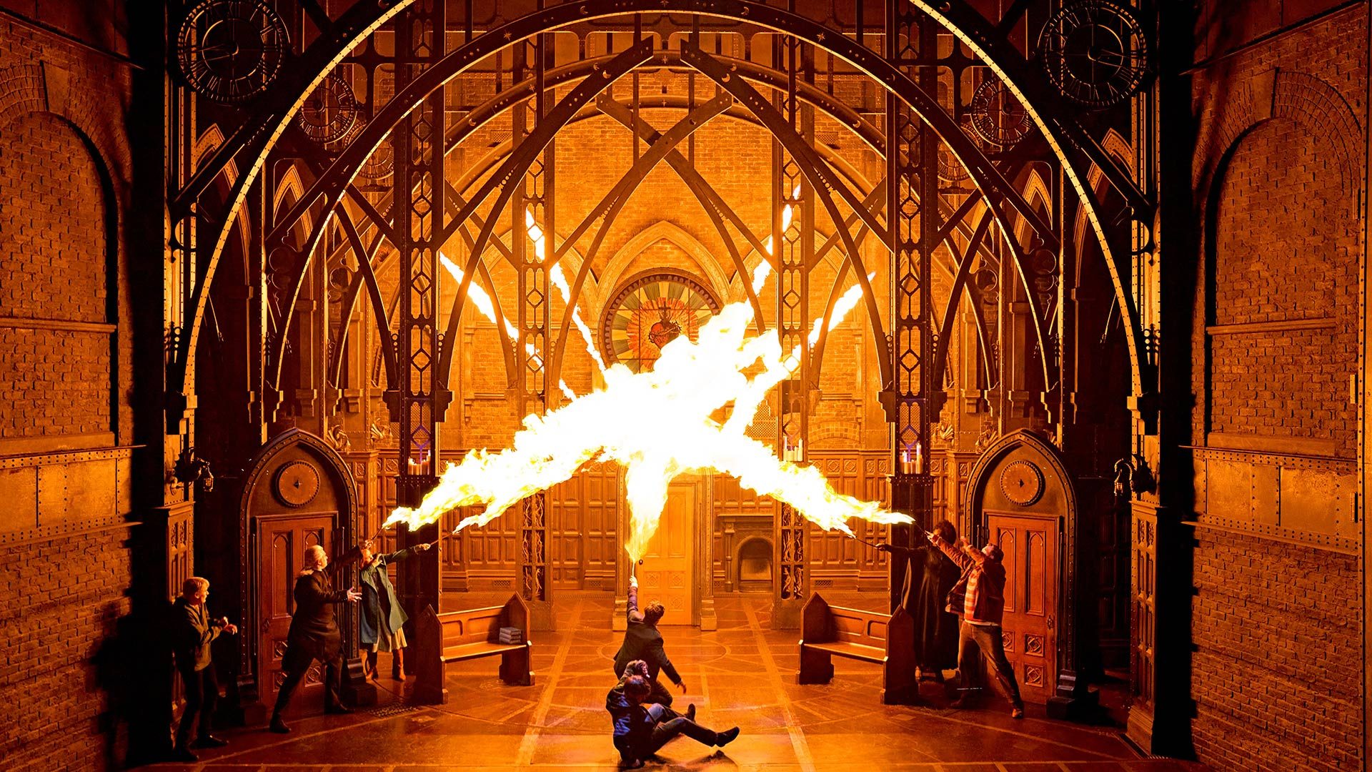 Harry Potter and the Cursed Child Stage scene from "Harry Potter and the Cursed Child" with dramatic fire effect and gothic arches.